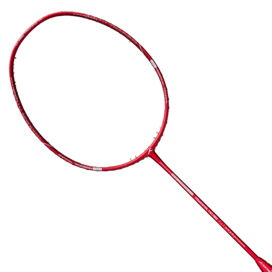 Red badminton racket on a black background